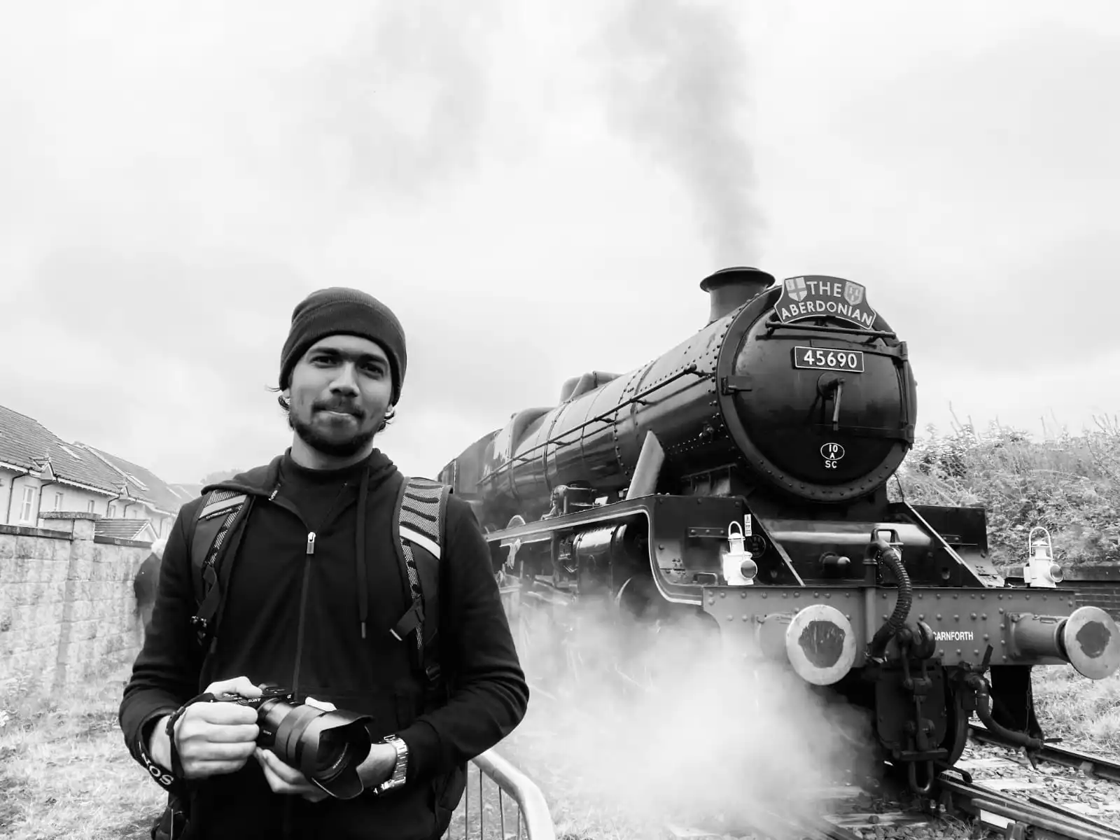 the best digital marketing expert in kollam kerala holding a camera near a steam locomotive